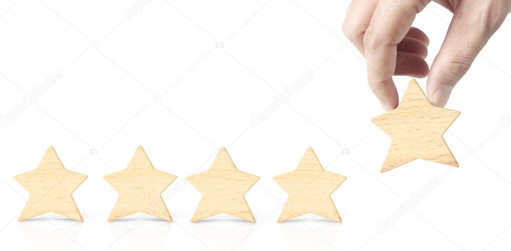 Wooden five star in hand shape. The best excellent business services rating customer experience concept