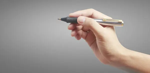 Hand holding a pen writing something text isolated