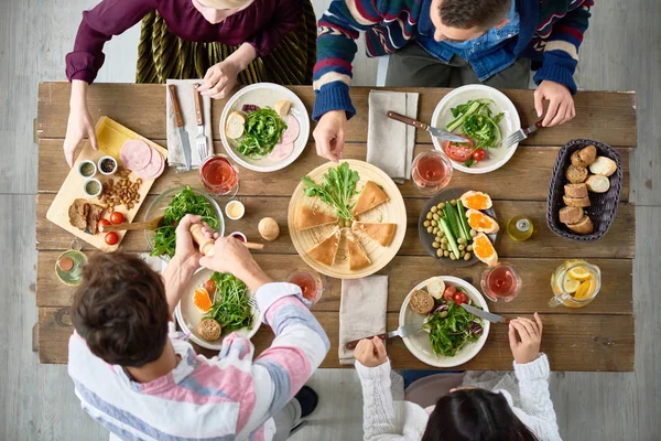 View Four People Eating Delicious Food Festive Dinner Table Cafe — Stock Photo, Image