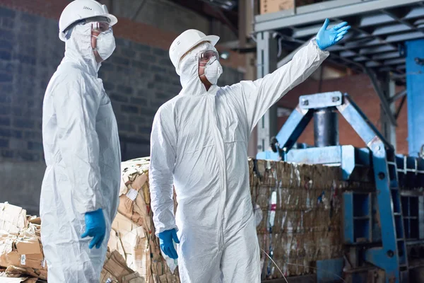 Portrait Two Workers Wearing Biohazard Suits Standing Industrial Warehouse Modern — Stock Photo, Image