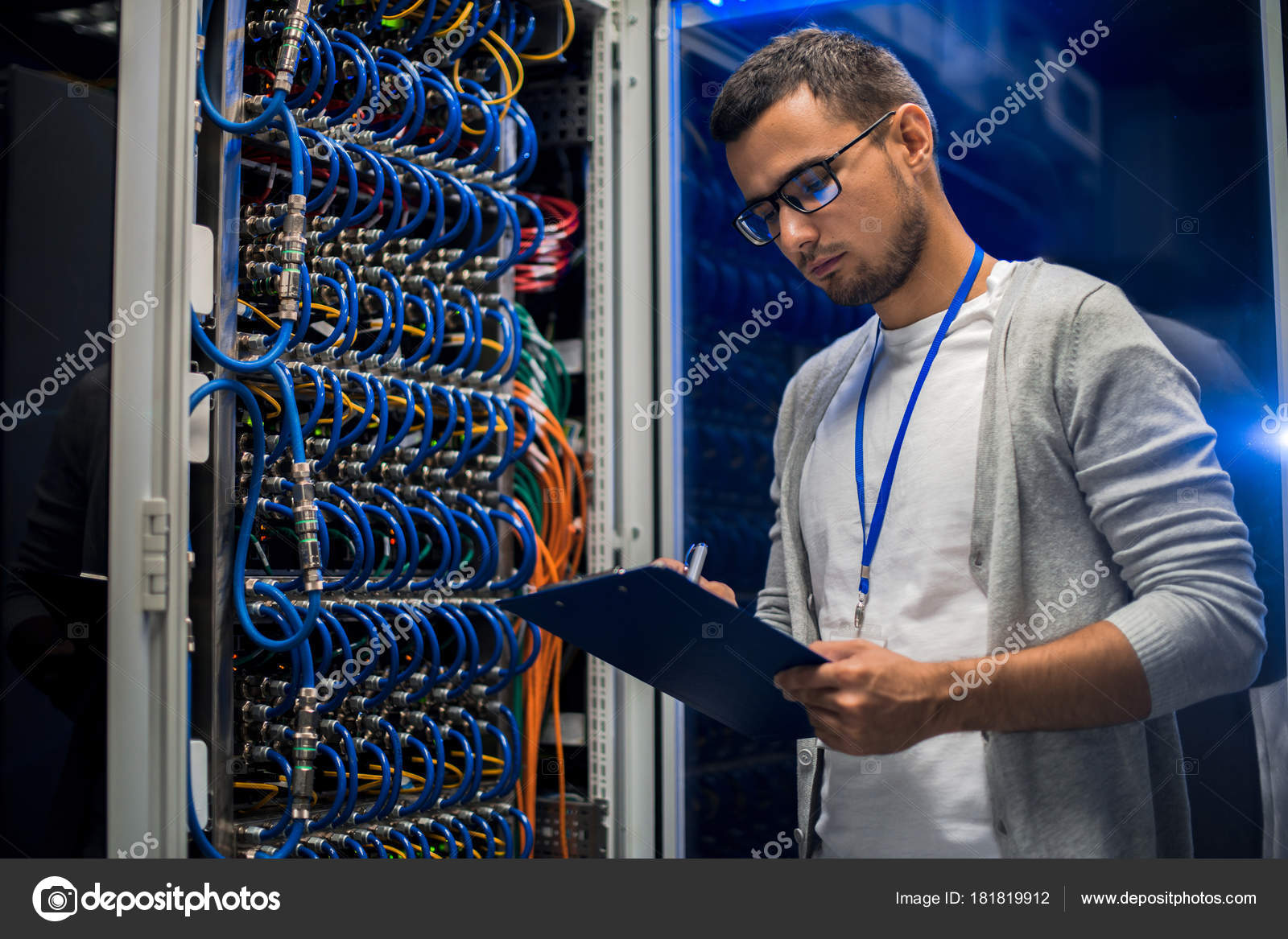 Portrait Young Network Engineer Standing Server Cabinet While