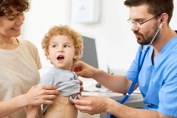 Portrait Cute Curly Boy Sitting Mothers Lap Medical Checkup While — Stock Photo, Image