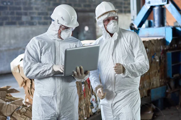 Portrait Two Workers Wearing Biohazard Suits Using Laptop Industrial Warehouse — Stock Photo, Image