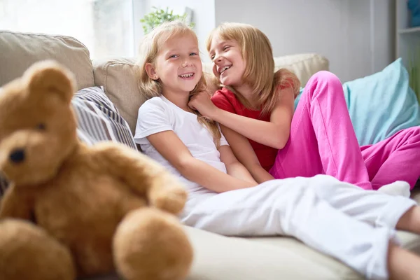 Portret Van Twee Gelukkige Zusjes Zittend Een Comfortabele Bank Gezellige — Stockfoto