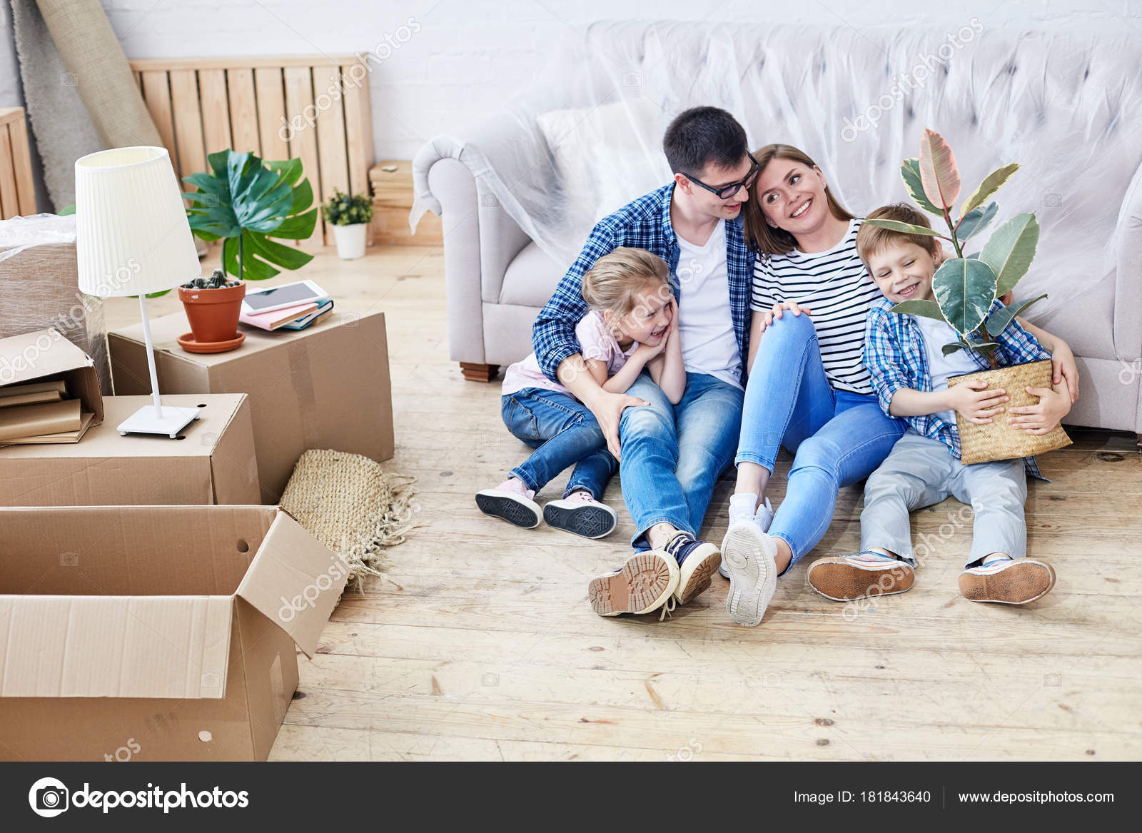 Full length portrait of loving young family gathered together in living  room of new apartment and sharing ideas concerning interior design, cute