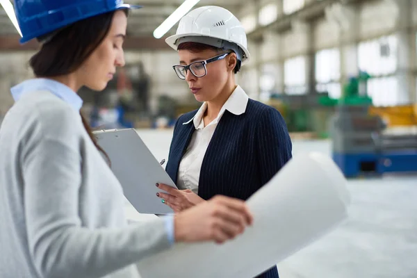 Σοβαρή Κυρία Απασχολημένος Hardhat Εργάζονται Στο Εργοστάσιο Και Καθιστώντας Σημειώσεις — Φωτογραφία Αρχείου