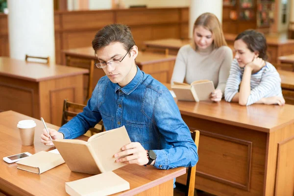 Estudante Universitário Concentrado Vestindo Camisa Jeans Óculos Tomando Notas Necessárias — Fotografia de Stock