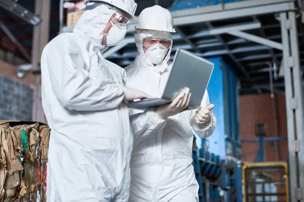 Portrait Two Workers Wearing Biohazard Suits Using Laptop Industrial Warehouse — Stock Photo, Image