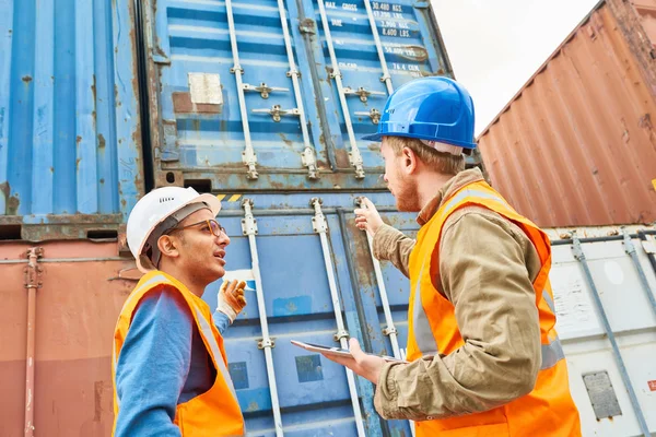 Two Confident Supervisors Wearing Reflective Vests Hardhats Discussing Details Loading Royalty Free Stock Photos