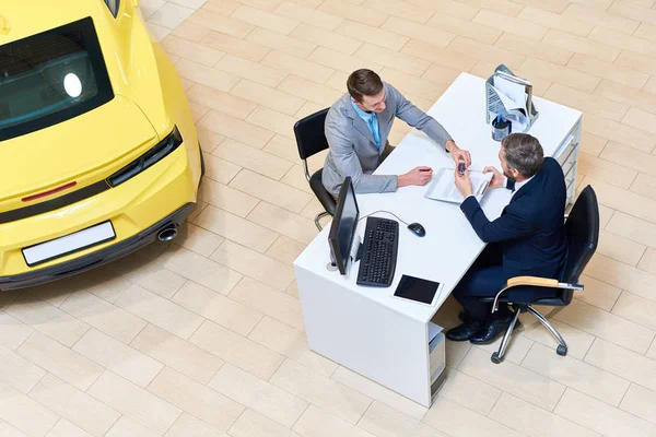 View Young Businessman Signing Purchase Contract Sitting Desk Dealership Shop — Stock Photo, Image