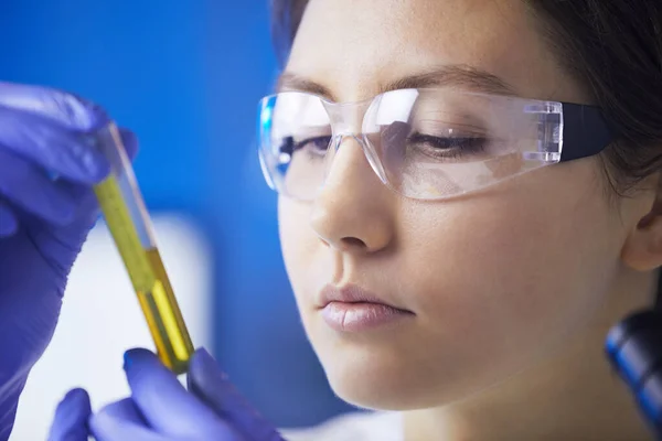 Closeup Beautiful Young Woman Looking Test Tube Colored Liquid While — Stock Photo, Image