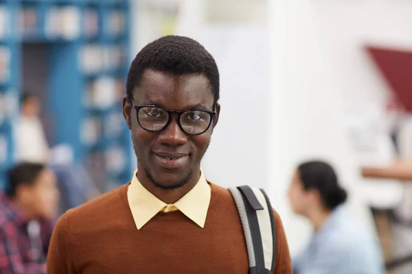美国黑人学生站在现代大学图书馆时 面带微笑地看着相机的头像和肩像 复制空间 — 图库照片