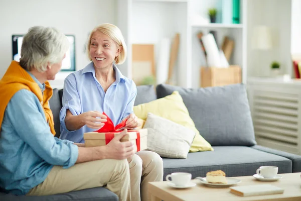 Portrait Excited Senior Woman Opening Gift Caring Husband Sitting Comfortable — Stock Photo, Image