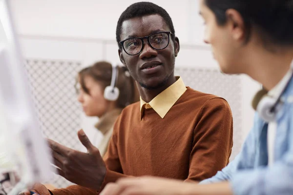 Portrait African American Student Wearing Glasses Talking Classmate While Using — ストック写真