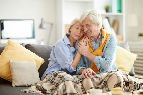 Portrait Loving Senior Couple Embracing Tenderly Sitting Comfortable Couch Home — Stock Photo, Image