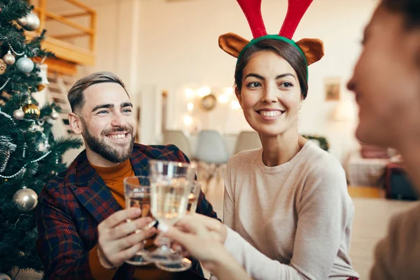 Noel Partisinde Arkadaşlarıyla Şampanya Kadehlerini Tokuştururken Mutlu Bir Şekilde Gülümseyen — Stok fotoğraf