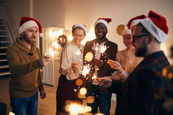 Multi Ethnic Group People Holding Sparkling Lights While Enjoying Christmas — Stock Photo, Image