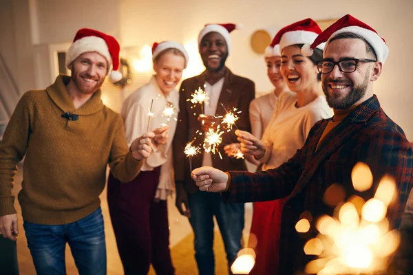 Multi Ethnic Group People Holding Sparkling Lights Looking Camera While — Stock Photo, Image