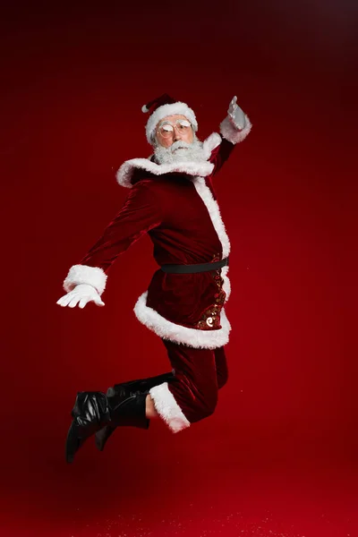 Full Length Portrait Classic Santa Claus Jumping High Red Background — Stock Photo, Image