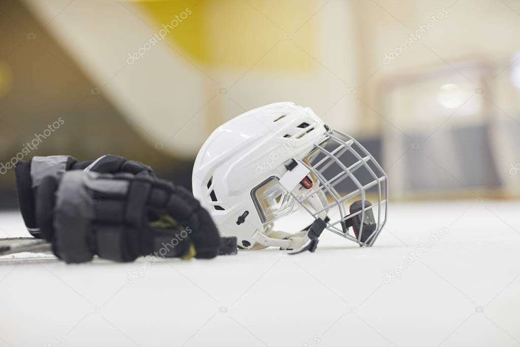 Background image of hockey equipment lying on ice in outdoor skating arena, copy space
