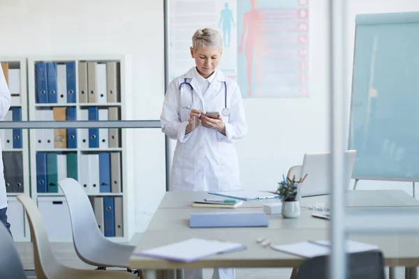 Porträtt Mogna Kvinnliga Läkare Med Hjälp Smartphone När Står Vid — Stockfoto