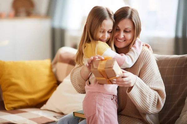 Warm Toned Portrait Cute Girl Hugging Mom Giving Gift Birthday — Stock Photo, Image