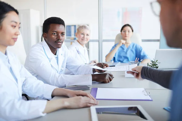 Portrait Young African American Doctor Taking Contract Document While Sitting — Stock Photo, Image