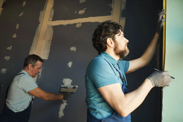 Low angle view of construction crew working in room while building or renovating house, copy space