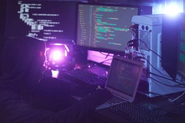 Tanımlanamayan hacker 'da karanlık odadaki ekranlarda programlama kodu olan bilgisayar donanımı, siber güvenlik konsepti, kopyalama alanı
