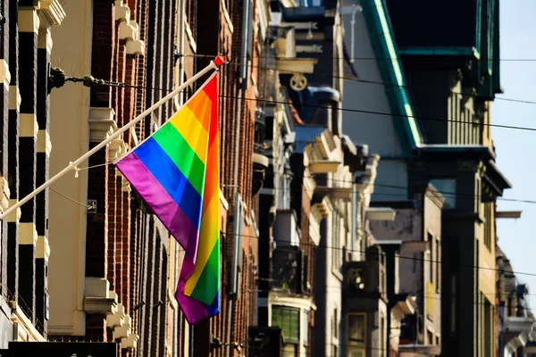 Rainbow banner on a house facade in Amsterdam