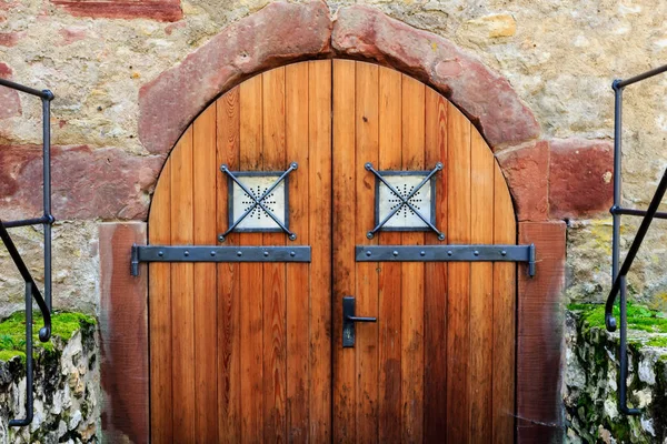 Old wooden gate to the dungeon in a castle ruin