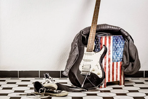 Elektro gitar, deri ceket ve spor ayakkabı