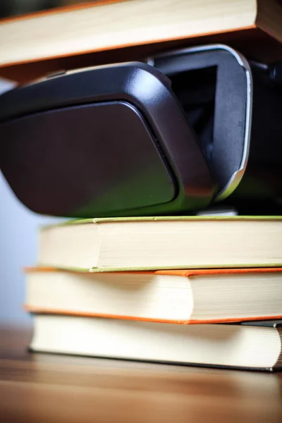 VR glasses and books on a table symbolizing digital learning
