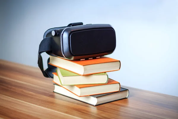 VR glasses and books on a table symbolizing digital learning