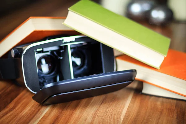 VR glasses and books on a table symbolizing digital learning