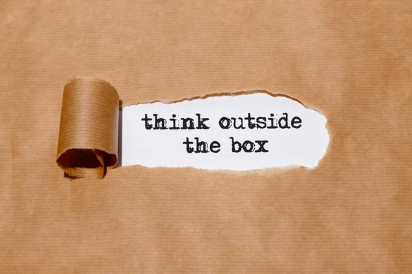 "think outside the box" behind torn paper — Stock Photo, Image