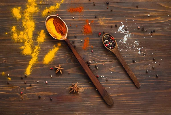 Wooden spoons and ingredients on a dark background. — Stock Photo, Image