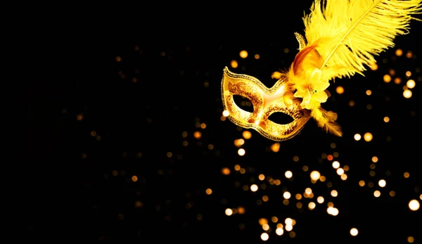 Masquerade mask on black background with sparkles. The concept of traditional holidays. Close-up — ストック写真