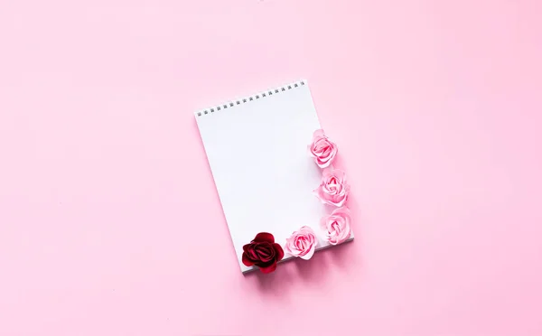 Festive concept with notebook and rosebuds on pink background. Valentines Day. Template mock up of greeting card or text design. Close-up — Stock Photo, Image