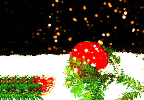 Christmas decorations on snow texture on black background with sparkles. Blurry effect. Copy space — Stock Photo, Image