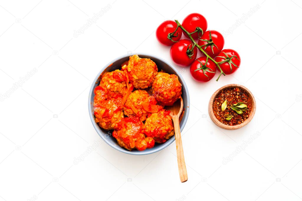 Meatballs in blue bowl on white isolated background. Close-up, copy space