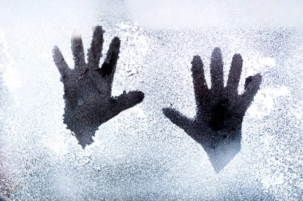 Pattern of hands on frosty window. Christmas background. Copy Space