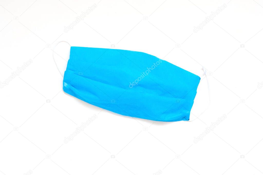 Medical blue mask for hygiene and protection against coronavirus on white isolated background. Sustainable health. Close-up, copy space
