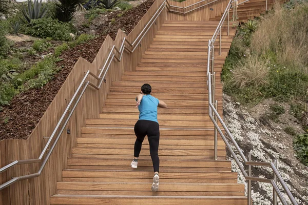 Woman Running Blue Shirt Climbing Wooden Staircase — Stock Photo, Image