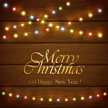Yazı ile ahşap arka plan üzerinde renkli Noel ışıkları