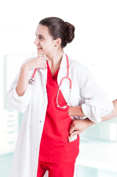 Female doctor getting money from male patient — Stock Photo, Image