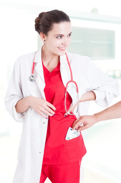 Concept of corruption with woman doctor accepting bribe — Stock Photo, Image