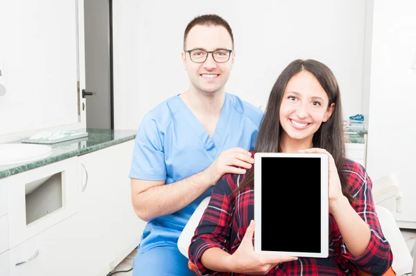 Orthodontist and patient holding tablet and smiling — Stock Photo, Image