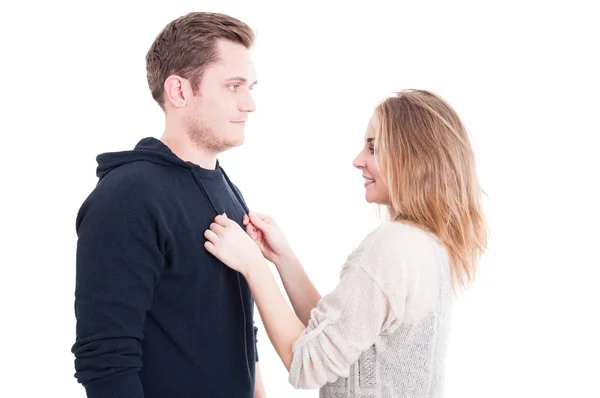 Pretty woman fixing man's autumn casual sweater — Stock fotografie