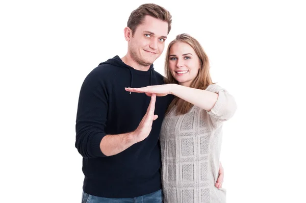 Smiling couple showing timeout gesture with hands — Stockfoto